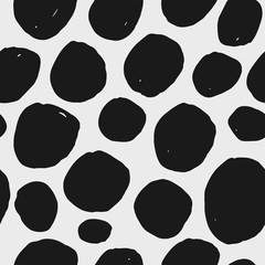 Abstract hand drawn vector seamless pattern. Black and white polka dot background