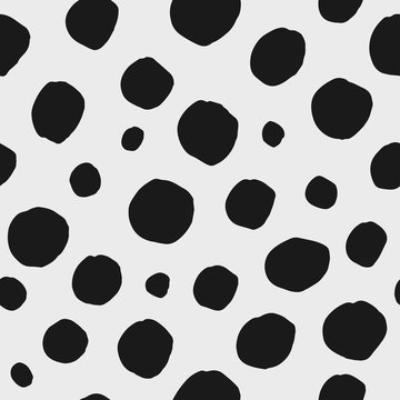 Abstract hand drawn vector seamless pattern. Black and white polka dot background