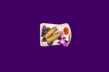 Asian Thai food on white plates with purple background with copy space