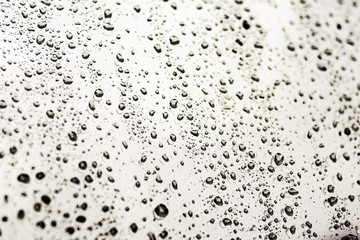 Autumn rain on the car glass. Water drop on windshield background texture.