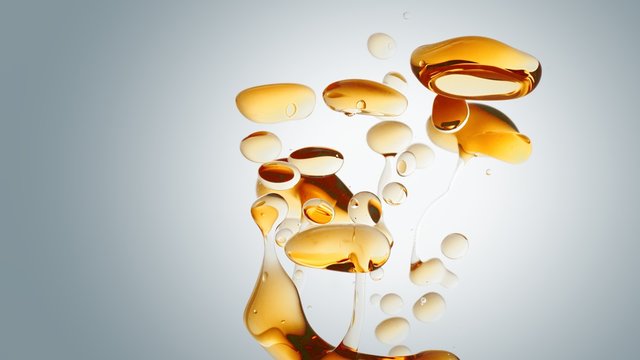 transparent orange gold oil bubbles and fluid shapes in purified water on a white gradient background. Side angle with crystal colored bubbles in purified cosmetic water backdrop with copy space for s