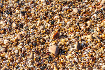 sea pebbles colored granite on the beach