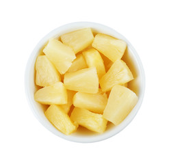 Bowl with pieces of delicious sweet canned pineapple on white background, top view