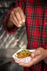 Sprinkle scalions on shrimp creole close vertical