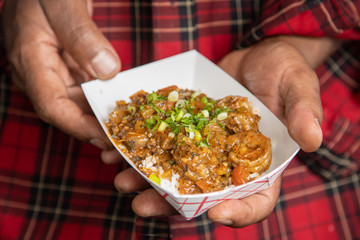 Closeup shrimp creole horizontal holding with two hands