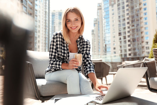 Beautiful Woman With Laptop And Coffee At Outdoor Cafe