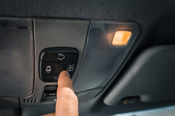 Saving energy and car battery charge - hand turns off car interior lighting