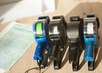 various label guns stand on the desktop