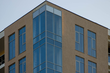 Obraz premium Abstract image of looking up at modern glass and concrete building. Architectural exterior detail of industrial office building. Industrial art and detail.