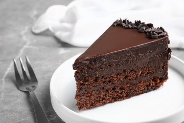 Delicious fresh chocolate cake served on grey table, closeup