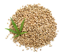 Pile of hemp seeds and leaf on white background, top view