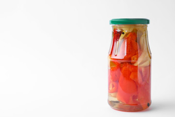 Fototapeta na wymiar Jar with pickled bell peppers on white background
