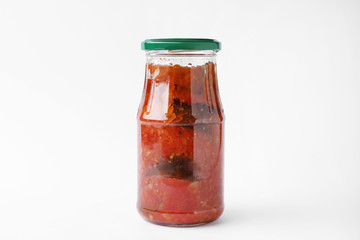 Jar with tasty vegetable sauce on white background. Pickled food