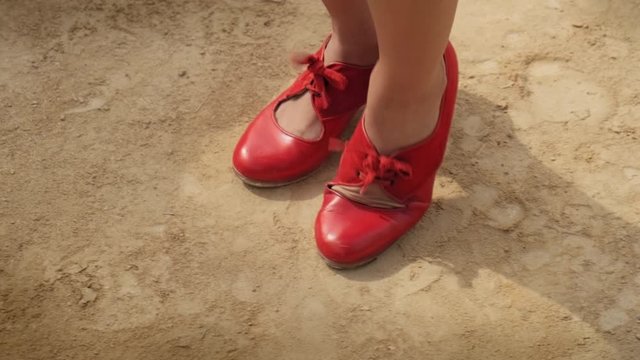 Man and woman dancing flamenco in park. Spanish people and traditional dance in Andalusia, Spain. Dancers performing traditional show in park. Couple and music arts. Detail of female feet and dress