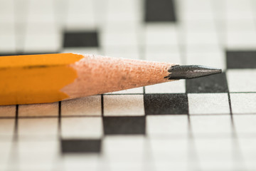 Closeup of a Pencil on Top of a Crossword Puzzle