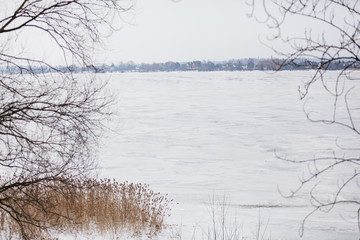 winter rural landscape with a river and trees