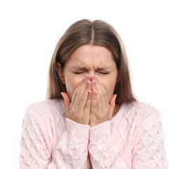 Young woman suffering from cold on white background