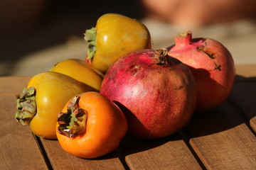 Fototapeta na wymiar Autumn harvest in the mediterranean island of Crete: pomegranates, walsnuts, lotus