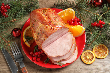 Plate with delicious ham served on wooden table, flat lay. Christmas dinner