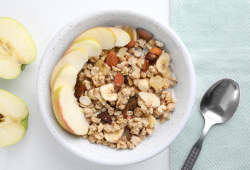 Flat lay composition with muesli and apples on white wooden table. Healthy breakfast