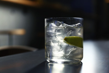 Glass of delicious cocktail with vodka on counter in bar