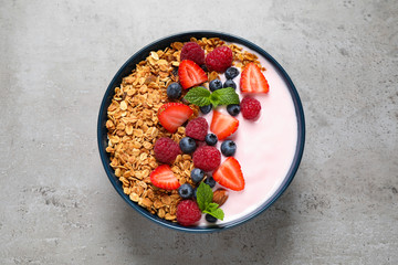 Tasty homemade granola with yogurt on grey table, top view. Healthy breakfast