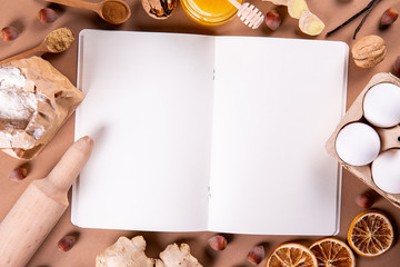 Traditional christmas holidays pastry ingredients and various kitchen utensils on paper textured background. Ginger cookies recipe concept. Close up, copy space, top view, flat lay.