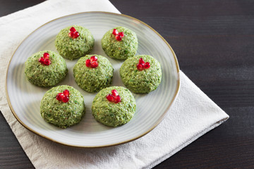 Pkhali with beans on a dark wooden background. Traditional Georgian dish of vegetables, nuts and spices