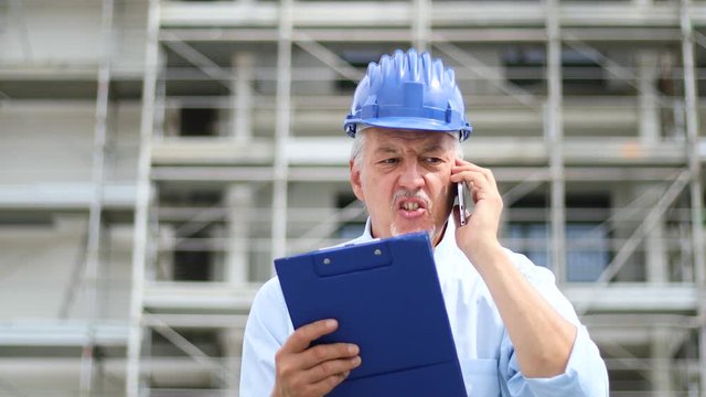 Angry senior engineer shouting at the phone