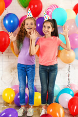 Happy children near bright balloons at birthday party indoors