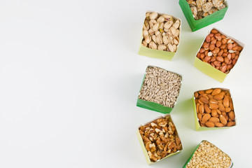 Paper bags with pistachios sunflower seeds walnuts cashew peanut almond pine nuts