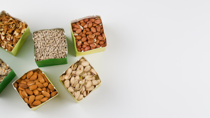 Paper bags with pistachios sunflower seeds walnuts cashew peanut almond pine nuts