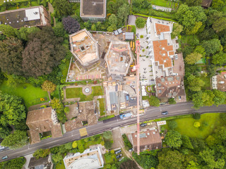 Aerial view of construction site with large crane in European town.