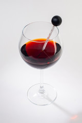 Glass of red wine on a white background and with soft shadow.