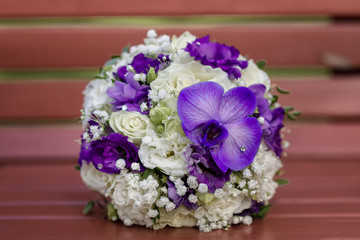 Bridal bouquet of white and purple flowers
