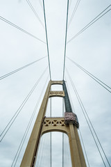 Fototapeta premium The South tower of the Mackinac Bridge being repainted. The bridge spans the Straits of Mackinac between the upper and lower peninsulas of Michigan, USA.