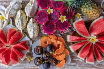 Tropical fruits assortment, closeup, top view. Many colorful ripe fruits background. Durian, papaya, watermelon, banana, mangosteen, pineapple and pitahaya or dragon fruit in island Bali, Indonesia