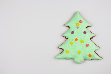 Christmas homemade gingerbread cookies on a white background. Sweet colored gingerbread cookies, place for text. Christmas tree. Copyspace