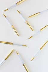 Scattered gold and crystal pens