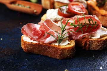 Assorted bruschetta with various toppings. Appetizing bruschetta or brie crostini. Variety of small sandwiches. Mix bruschetta on table