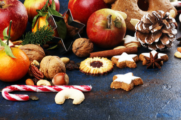 christmas cookies and santa had with spieses, nuts and fruits on rustic table