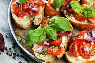 fresh tomato bruschetta. italian food appetizer with basil on table