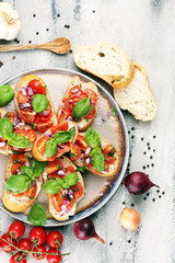 fresh tomato bruschetta. italian food appetizer with basil on table