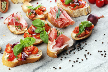 Assorted bruschetta with various toppings. Appetizing bruschetta or crudo crostini. Variety of small sandwiches. Mix bruschetta on table