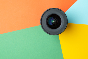 one modern photo lens on a colored background, digital color rendering concept