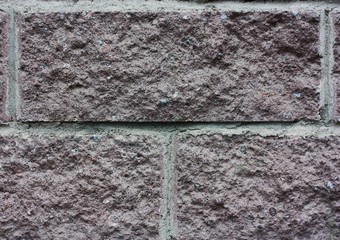 Gray brick wall of the house close up 