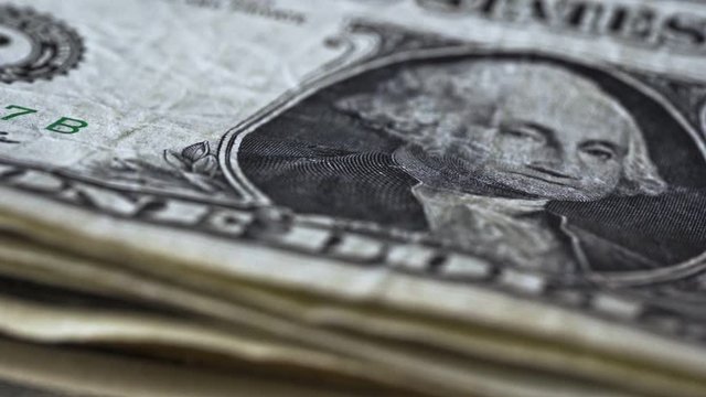 Slowmotion view of US Dollars falling, macro shot.