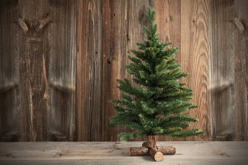 One Green Christmas Tree. Brown Rustic Wooden Background Or Texture With Copy Space