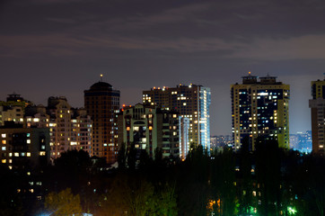 Fototapeta na wymiar Beautiful modern city at night. Panoramic view of the metropolis. The lights of the big city