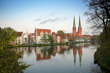 Cityscape of the historic old town of Luebeck at the Malerwinkel,  or painter's corner, two towers of the cathedral, in German Dom, reflection in f the river Trave, blue sky, copy space